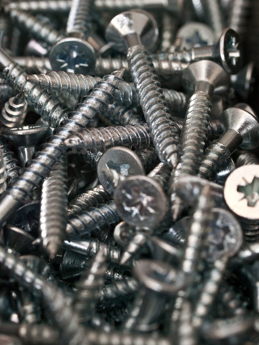 a bunch of screws and nuts in a pile